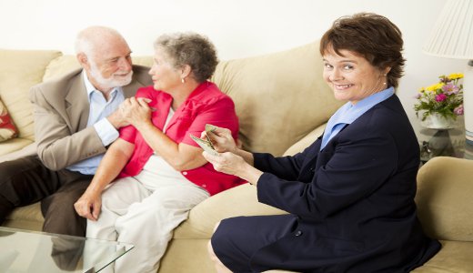 Successful saleswoman counting her money in the home of satisfied customers.