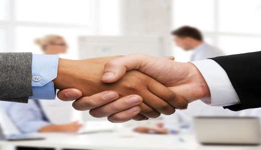 businessman and businesswoman shaking hands